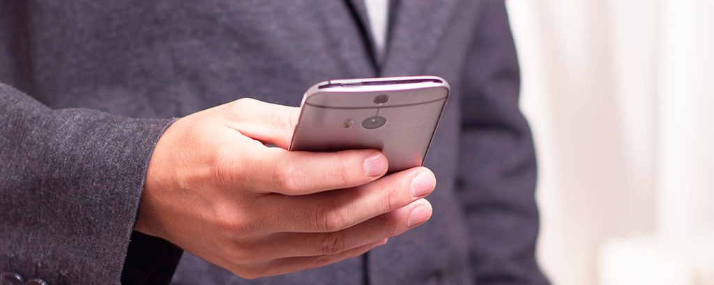 man in suite using a cell phone