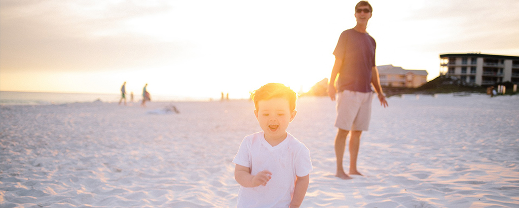 dad playing in cancun beach with son